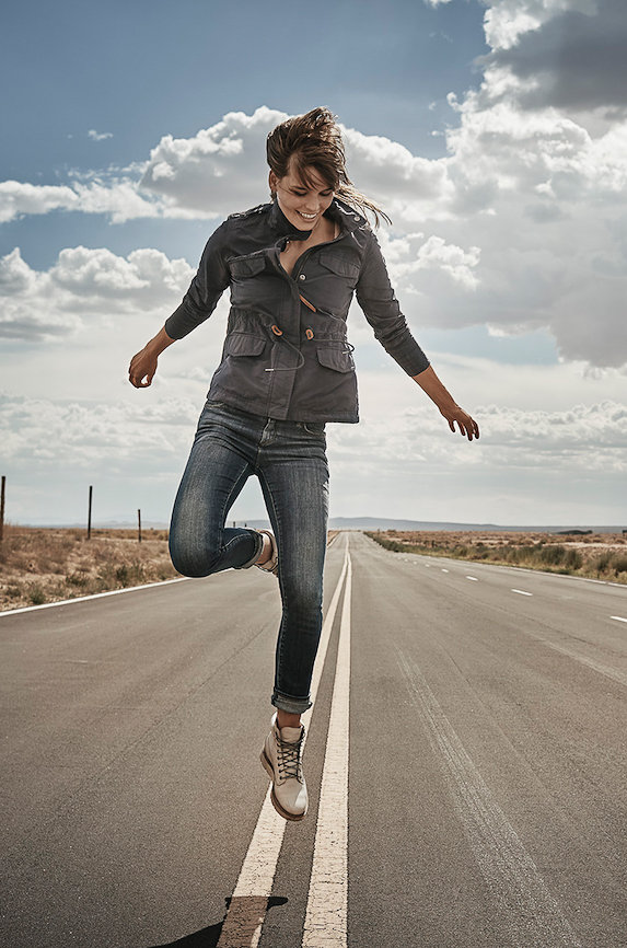 girl_jumping_in_air_on_hiway_timberland